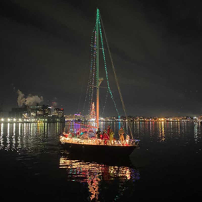 boat decorated with holiday lights